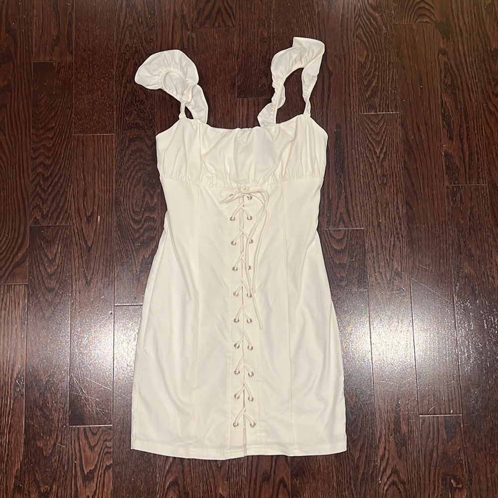 White lace up dress with ruffled sleeves.